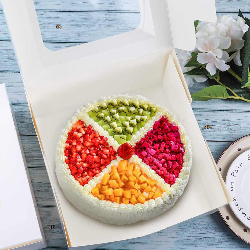 mini fruit cake in a white paper box looking very inviting