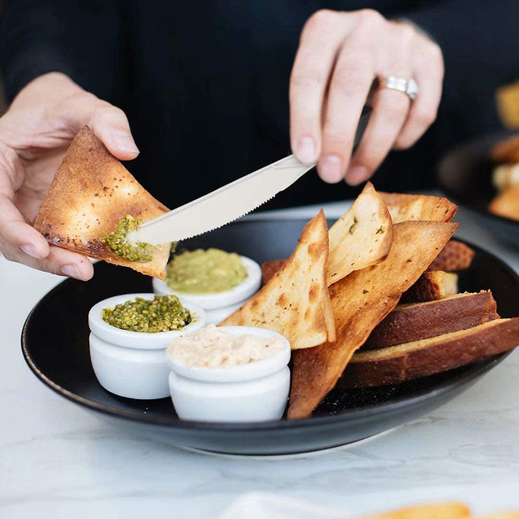 7" Compostable PLA Bio Knife scraping of the extra dressing off a bread