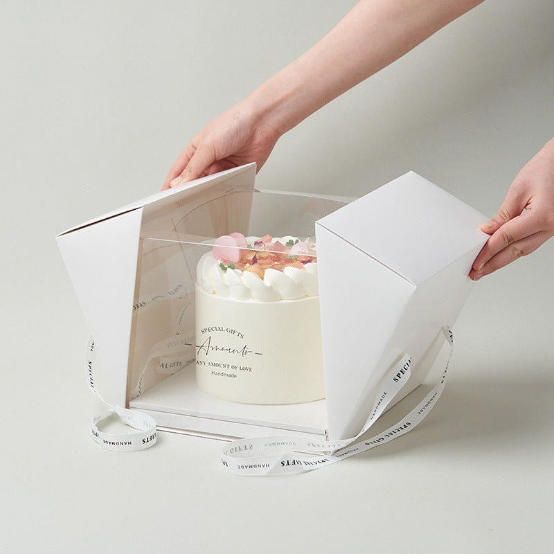 White cake box with cake inside and a ribbon opening