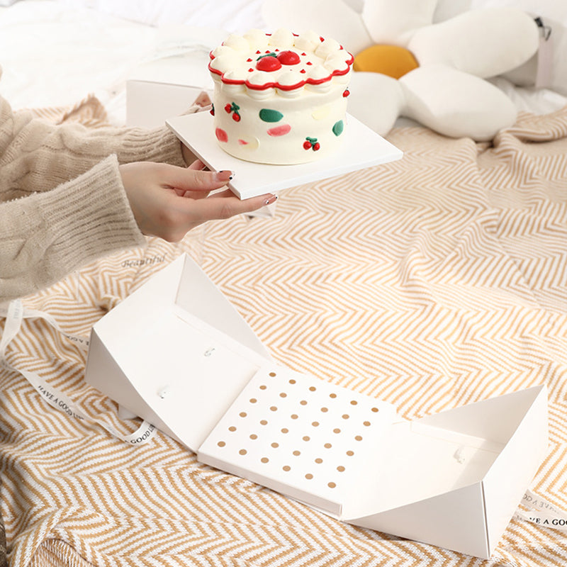 White cake box with cake inside