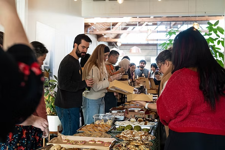 Food packaging boxes for event sponsorship displayed neatly on a table.